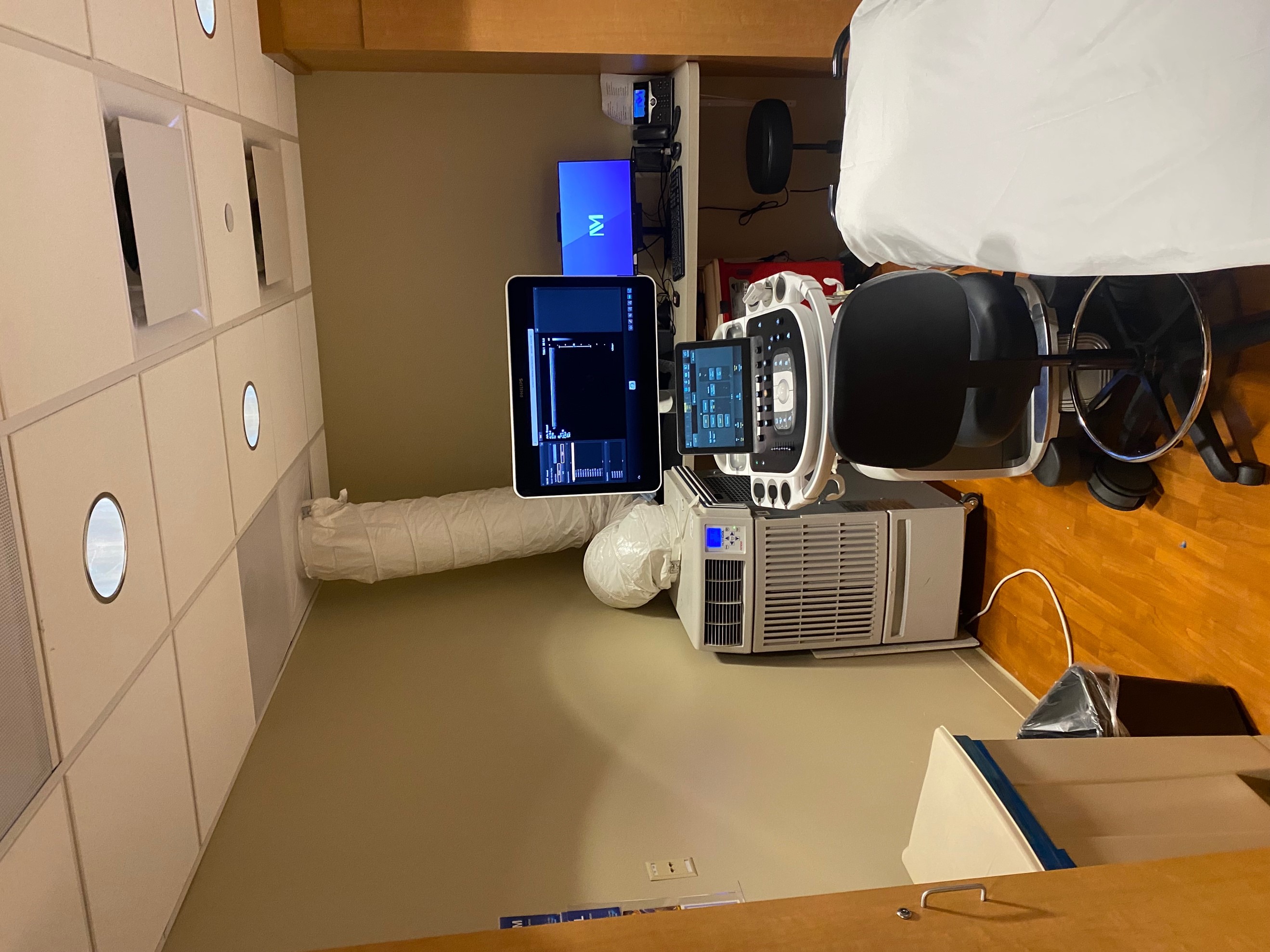Mobile unit AC installation in patient room with condenser duct attached to the drop ceiling. 